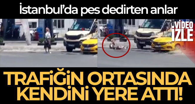 Trafik ışıklarında kendini yere atan kadın kamerada
